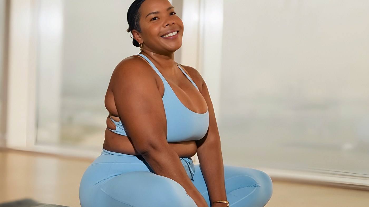 Chloe Pierre seated on a mat before a breathwork session